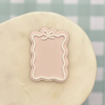 Decorative pink frame on a marble surface with a blurred background