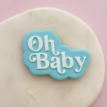 Decorative fondant with 'Oh Baby' text on a pink background