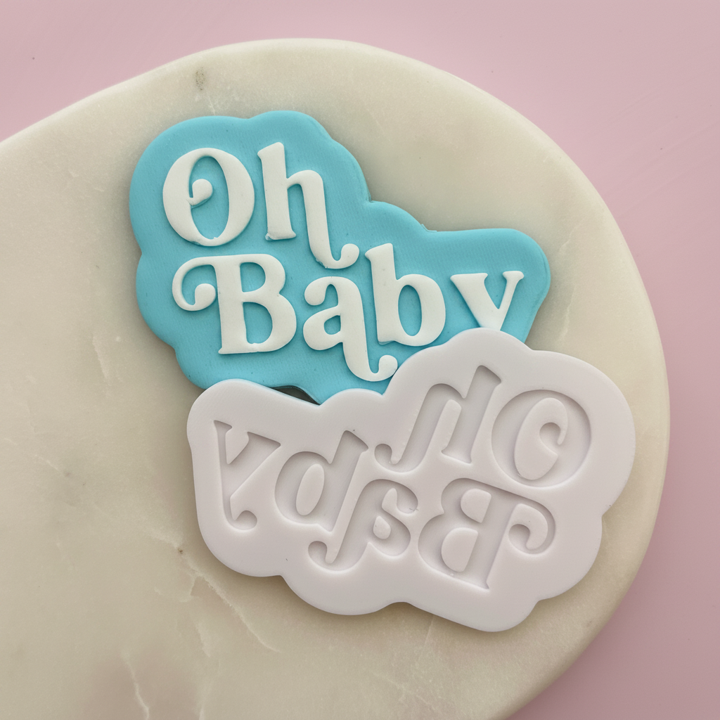 Decorative cookie cutters with 'Oh Baby' text on a pink background