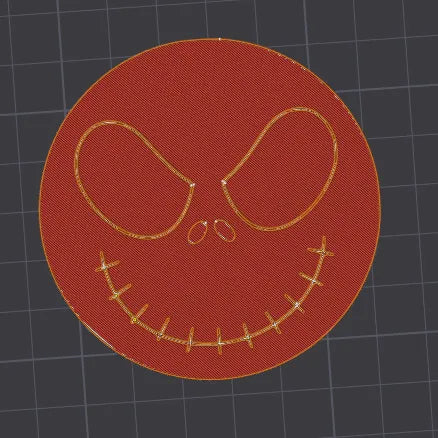 Red patch with gold embroidered face design on a grid background